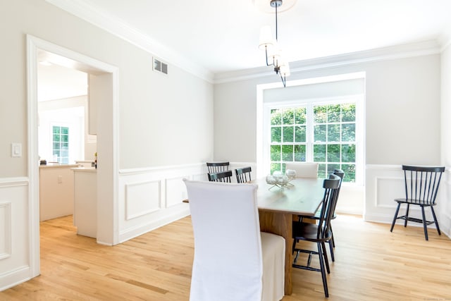 81 Salem Rd, Trumbull, CT 06611 - dining area featuring ornamental molding, light wood-type flooring, plenty of natural light, a wainscoted wall, and a decorative wall