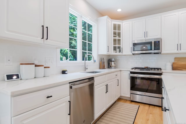 81 Salem Rd, Trumbull, CT 06611 - kitchen with stainless steel appliances, decorative backsplash, white cabinets, glass insert cabinets, and recessed lighting