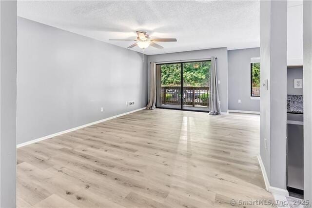 175 Mill Pond Rd Unit 203, Hamden, CT 06514 - unfurnished room with a ceiling fan, a textured ceiling, and light wood-style floors