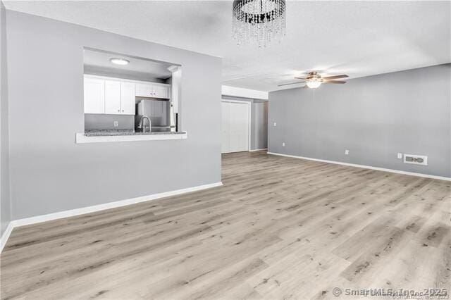 175 Mill Pond Rd Unit 203, Hamden, CT 06514 - unfurnished living room featuring ceiling fan and light wood-style flooring