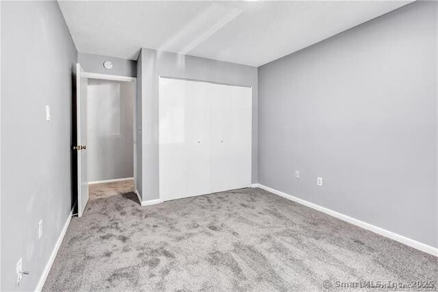 175 Mill Pond Rd Unit 203, Hamden, CT 06514 - unfurnished bedroom featuring carpet flooring and a closet
