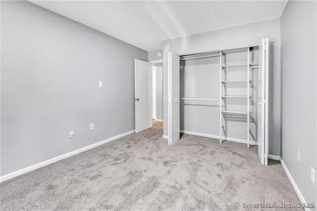 175 Mill Pond Rd Unit 203, Hamden, CT 06514 - unfurnished bedroom with carpet flooring and a closet