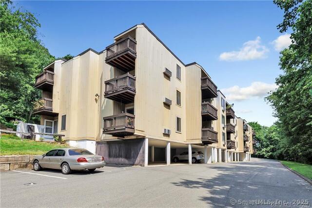 175 Mill Pond Rd Unit 203, Hamden, CT 06514 - view of apartment building / complex featuring uncovered parking