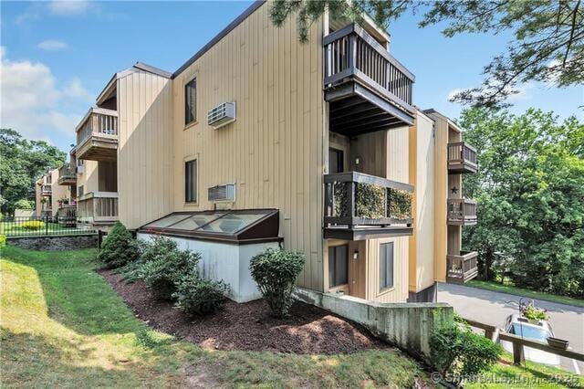 175 Mill Pond Rd Unit 203, Hamden, CT 06514 - view of property exterior featuring a balcony and a wall mounted air conditioner