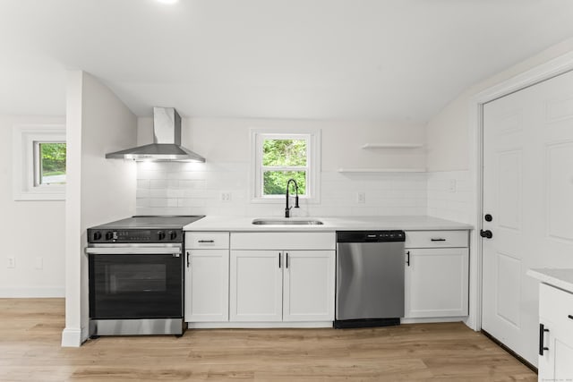 40 Clearview Rd, East Haddam, CT 06469 - kitchen with appliances with stainless steel finishes, wall chimney range hood, white cabinetry, and light countertops