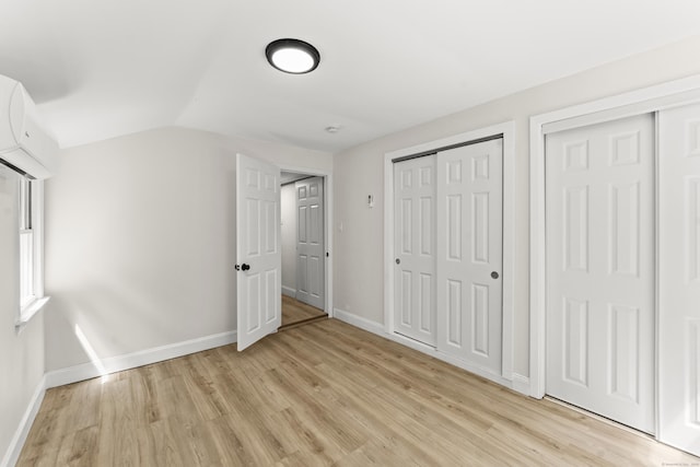 40 Clearview Rd, East Haddam, CT 06469 - unfurnished bedroom with light wood-style flooring, vaulted ceiling, and a wall mounted air conditioner