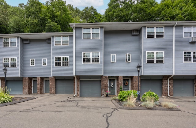 250 Summer St Unit 29, Southington, CT 06479 - view of front facade with a garage, brick siding, and driveway
