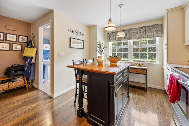 250 Summer St Unit 29, Southington, CT 06479 - kitchen featuring stainless steel range with electric stovetop, dark wood-style flooring, dark cabinets, a breakfast bar, and wooden counters
