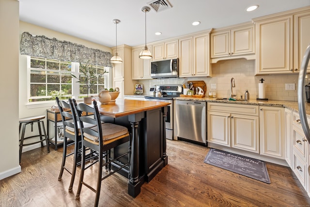 250 Summer St Unit 29, Southington, CT 06479 - kitchen featuring appliances with stainless steel finishes, cream cabinetry, light wood-style flooring, light stone countertops, and recessed lighting