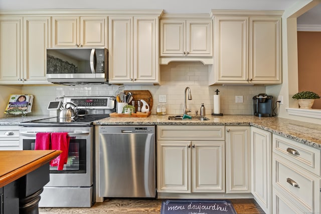 250 Summer St Unit 29, Southington, CT 06479 - kitchen featuring appliances with stainless steel finishes, cream cabinets, tasteful backsplash, and wood finished floors
