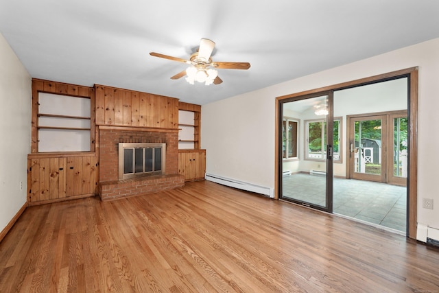 120 Knowles Ave, Southington, CT 06479 - unfurnished living room with baseboard heating, light wood finished floors, a ceiling fan, a fireplace, and wood walls
