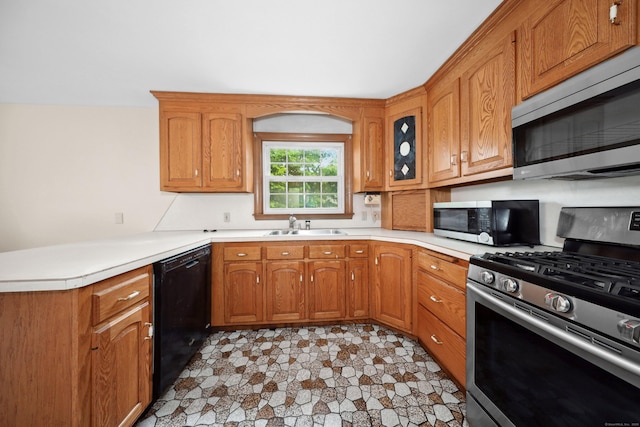 120 Knowles Ave, Southington, CT 06479 - kitchen featuring appliances with stainless steel finishes, a peninsula, light countertops, and brown cabinets
