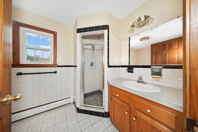 120 Knowles Ave, Southington, CT 06479 - full bathroom featuring tile walls, a baseboard radiator, vanity, a shower stall, and tile patterned floors