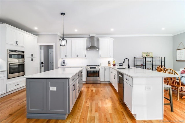11 Tall Oaks Dr Unit 11, New Milford, CT 06776 - kitchen featuring appliances with stainless steel finishes, wall chimney exhaust hood, a peninsula, a breakfast bar, and crown molding