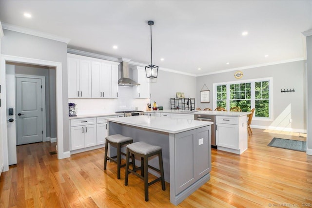 11 Tall Oaks Dr Unit 11, New Milford, CT 06776 - kitchen with wall chimney exhaust hood, dishwasher, a peninsula, a kitchen breakfast bar, and light countertops