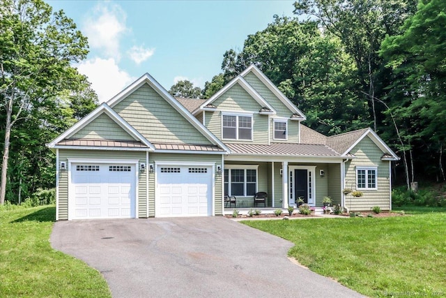 11 Tall Oaks Dr Unit 11, New Milford, CT 06776 - view of front of property with covered porch, a standing seam roof, asphalt driveway, a garage, and a front yard