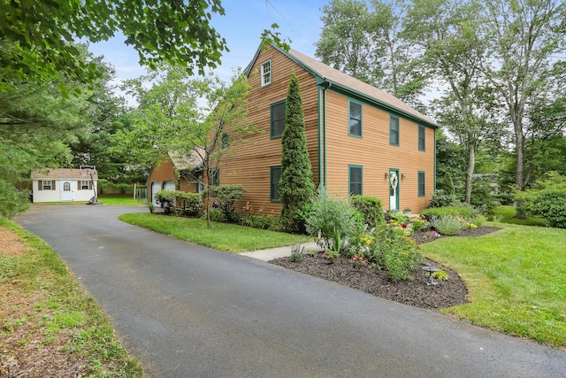 11 Park Ln, Trumbull, CT 06611 - view of property exterior featuring a yard, a garage, and an outbuilding