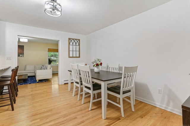 11 Park Ln, Trumbull, CT 06611 - dining area featuring light wood-style flooring and a baseboard radiator