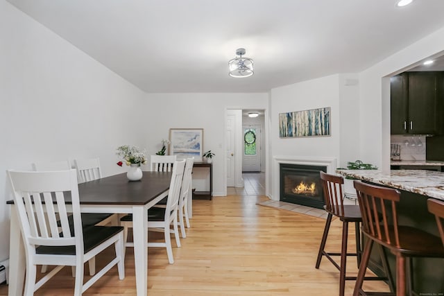 11 Park Ln, Trumbull, CT 06611 - dining space featuring light wood-style floors, a fireplace with flush hearth, recessed lighting, and baseboard heating