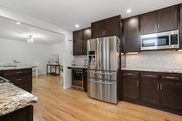 11 Park Ln, Trumbull, CT 06611 - kitchen featuring stainless steel appliances, wine cooler, decorative backsplash, light wood finished floors, and dark brown cabinetry