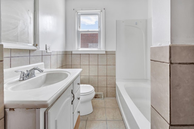 70 Sage Ave, Bridgeport, CT 06610 - full bath featuring a tub to relax in, vanity, tile walls, and tile patterned flooring