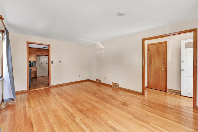 70 Sage Ave, Bridgeport, CT 06610 - empty room with light wood finished floors and a smoke detector