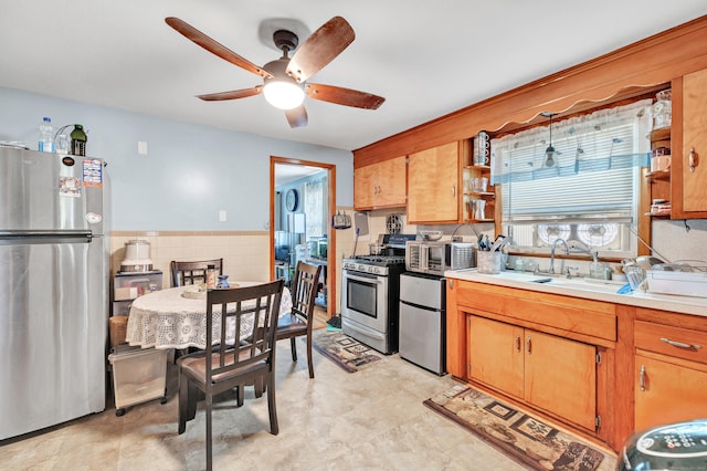 70 Sage Ave, Bridgeport, CT 06610 - kitchen featuring stainless steel appliances, open shelves, a ceiling fan, light countertops, and brown cabinets