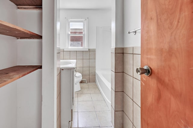 70 Sage Ave, Bridgeport, CT 06610 - bathroom with tile walls, tile patterned flooring, a tub, a wainscoted wall, and vanity