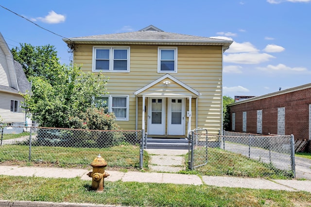 70 Sage Ave, Bridgeport, CT 06610 - view of front of house with a fenced front yard, a gate, and a detached garage