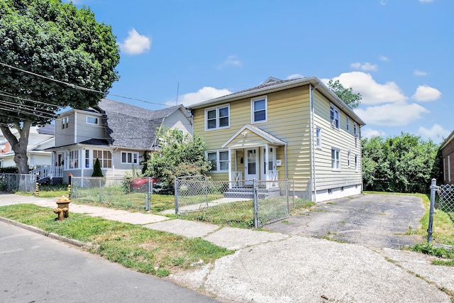 70 Sage Ave, Bridgeport, CT 06610 - view of front of house featuring a gate, a fenced front yard, and asphalt driveway
