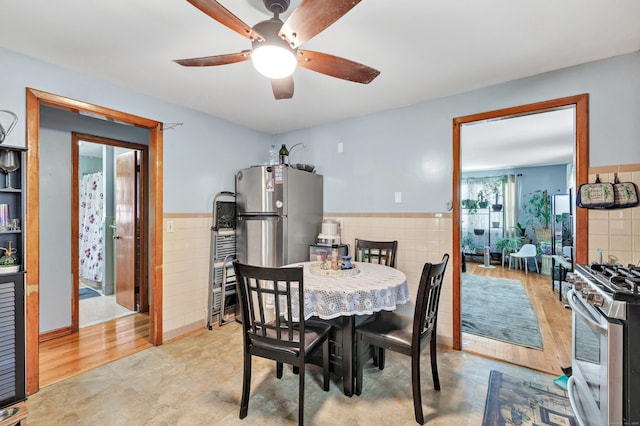 70 Sage Ave, Bridgeport, CT 06610 - dining area featuring tile walls, ceiling fan, wainscoting, and light wood-style floors