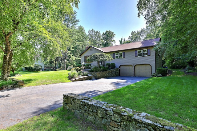 23 Fox Rd, Trumbull, CT 06611 - view of front facade with driveway, an attached garage, and a front yard