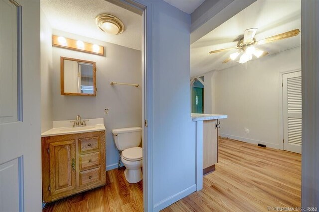 20 Mack Rd, Middlefield, CT 06455 - half bathroom with wood finished floors, vanity, and a ceiling fan