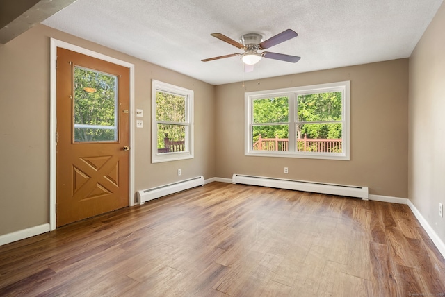 20 Mack Rd, Middlefield, CT 06455 - foyer entrance featuring a baseboard heating unit, wood finished floors, ceiling fan, and a textured ceiling