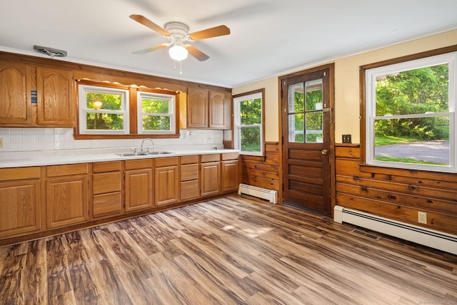 20 Mack Rd, Middlefield, CT 06455 - kitchen with a baseboard radiator, light countertops, brown cabinetry, wood finished floors, and wainscoting