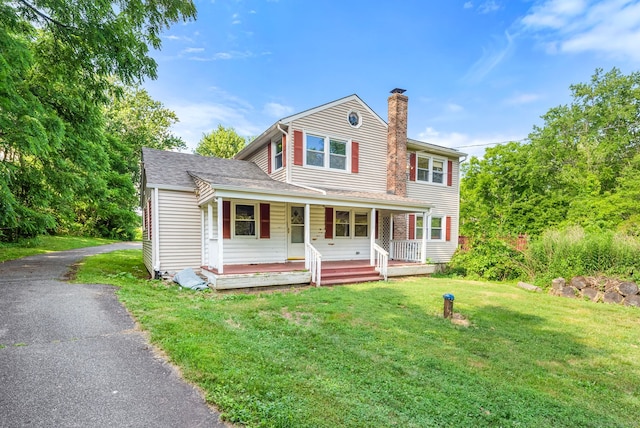 20 Mack Rd, Middlefield, CT 06455 - view of front facade featuring a chimney, covered porch, and a front lawn
