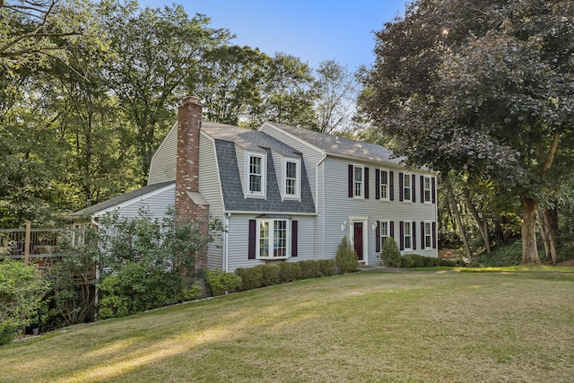 9 Allen Ct, Norwalk, CT 06851 - view of front of property featuring roof with shingles, a chimney, and a front yard