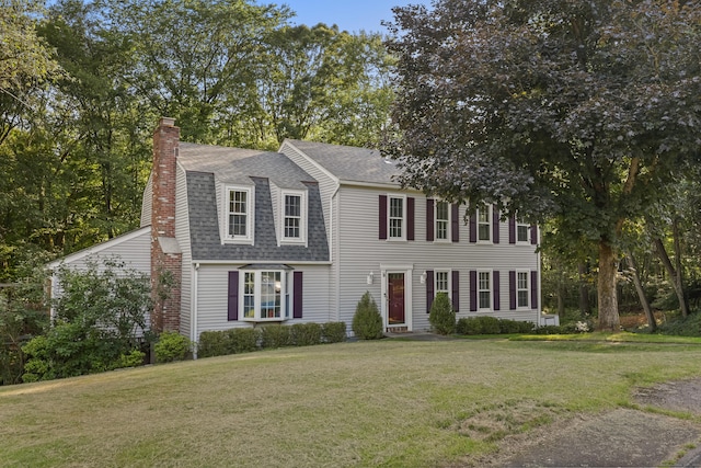 9 Allen Ct, Norwalk, CT 06851 - dutch colonial featuring roof with shingles, a chimney, and a front lawn