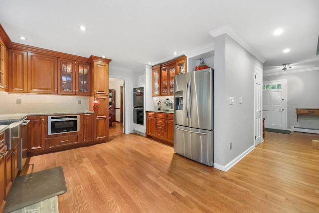 9 Allen Ct, Norwalk, CT 06851 - kitchen with appliances with stainless steel finishes, crown molding, baseboard heating, recessed lighting, and light wood-style floors