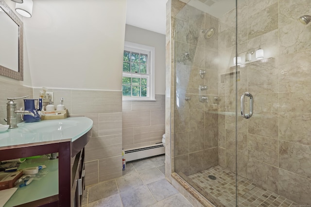 9 Allen Ct, Norwalk, CT 06851 - full bath with baseboard heating, vanity, a shower stall, tile walls, and wainscoting