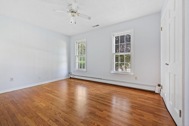 9 Allen Ct, Norwalk, CT 06851 - spare room featuring a baseboard heating unit, wood finished floors, and ceiling fan