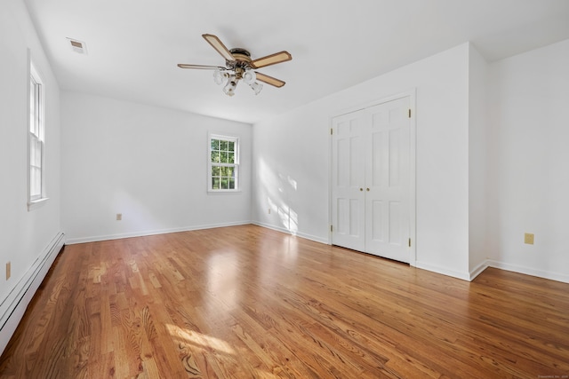 9 Allen Ct, Norwalk, CT 06851 - unfurnished bedroom featuring baseboard heating, wood finished floors, a ceiling fan, and a closet