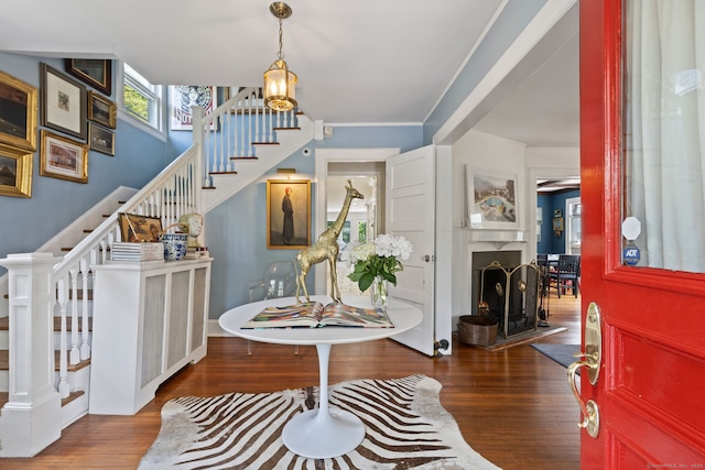 14 Highview Ave, Greenwich, CT 06870 - entryway with stairway, wood finished floors, a warm lit fireplace, and crown molding
