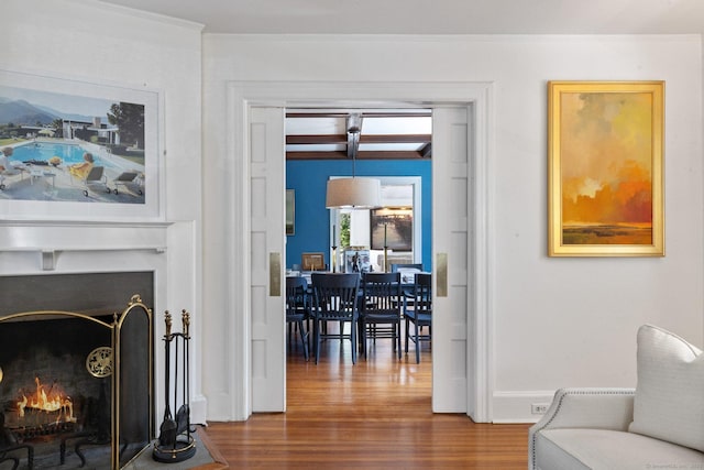 14 Highview Ave, Greenwich, CT 06870 - sitting room featuring wood finished floors, a lit fireplace, and crown molding