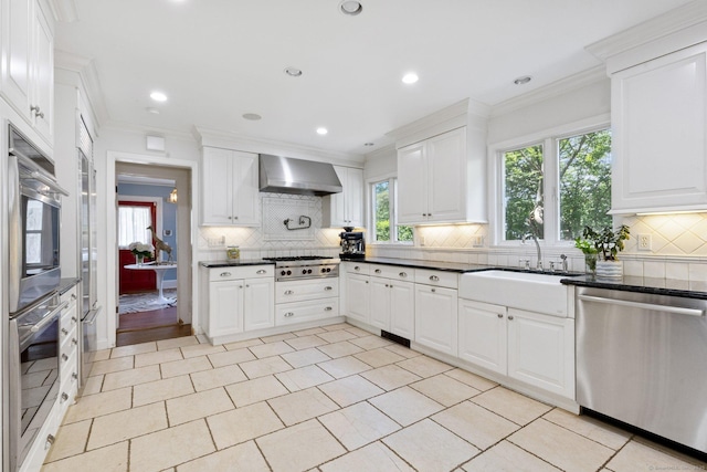 14 Highview Ave, Greenwich, CT 06870 - kitchen featuring stainless steel appliances, wall chimney exhaust hood, plenty of natural light, crown molding, and recessed lighting
