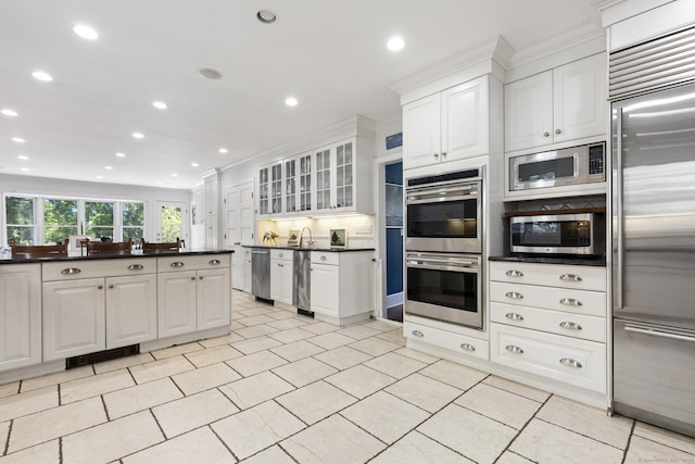 14 Highview Ave, Greenwich, CT 06870 - kitchen with built in appliances, dark countertops, white cabinets, recessed lighting, and glass insert cabinets