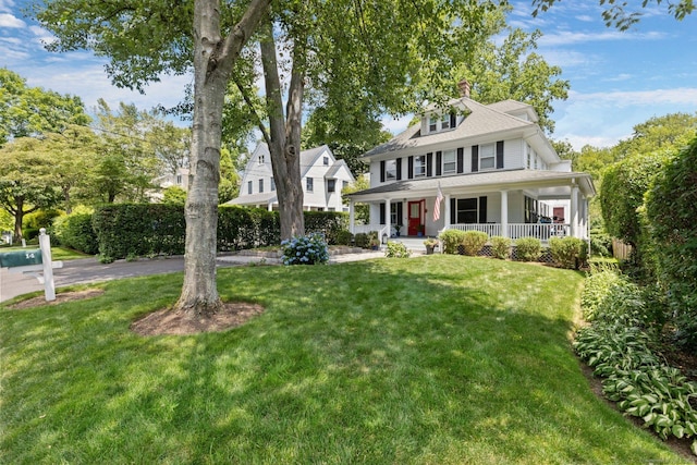 14 Highview Ave, Greenwich, CT 06870 - view of front facade with a porch, a front yard, and a chimney