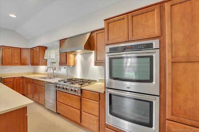 185 Chimney Hill Rd, Wallingford, CT 06492 - kitchen featuring stainless steel appliances, wall chimney range hood, brown cabinetry, light countertops, and vaulted ceiling