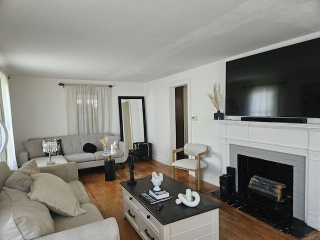 805 Savin Ave, West Haven, CT 06516 - living area with dark wood-type flooring and a brick fireplace