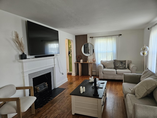805 Savin Ave, West Haven, CT 06516 - living room with arched walkways, a fireplace, and dark wood finished floors